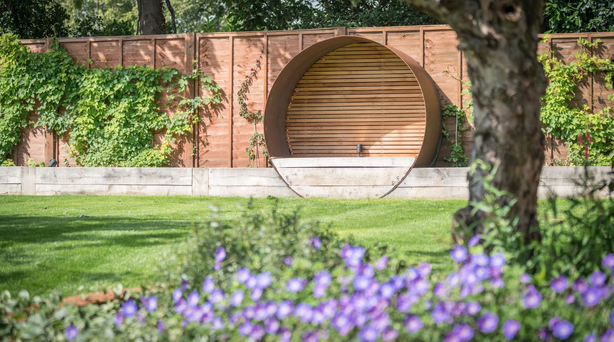 large circle seat set into garden fencing