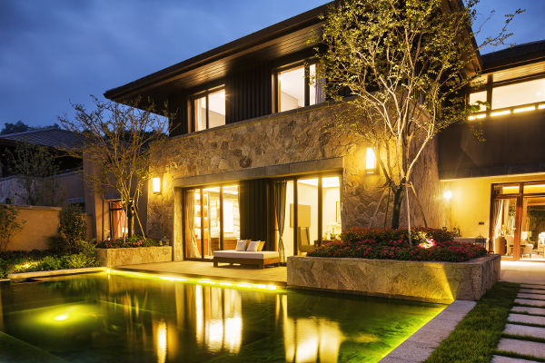 night scene of modern building near pond at night