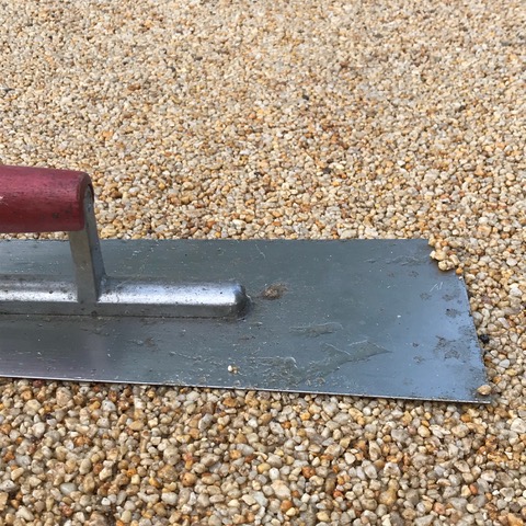 resin bonded shingle being laid