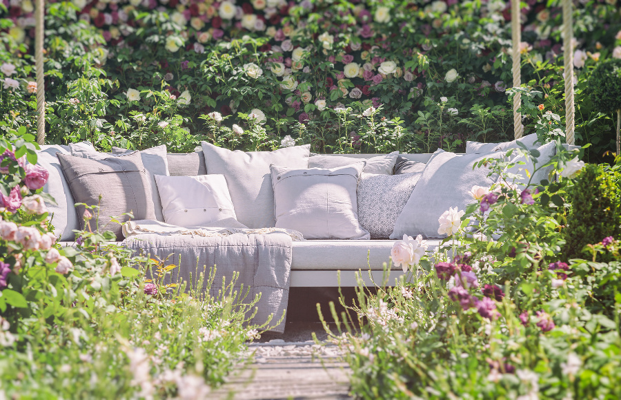 outdoor sofa in romantic garden setting