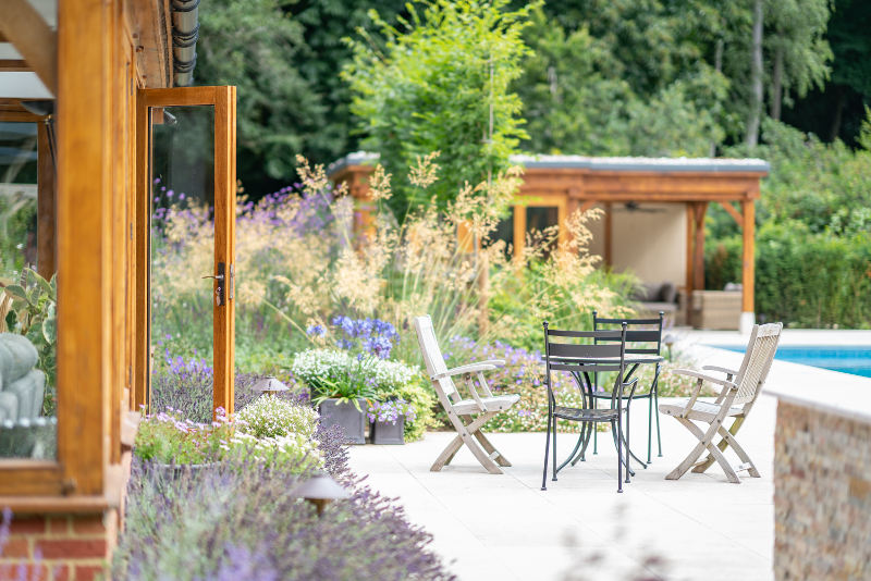 Patio seating area surrounded by planting