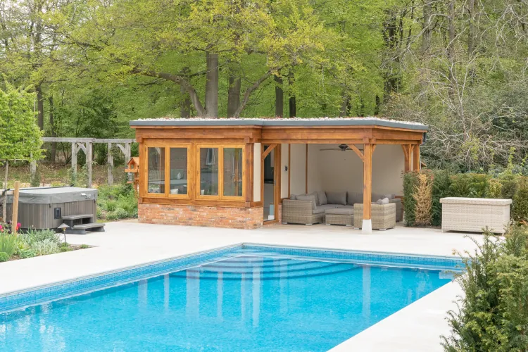Bespoke pool house with covered outdoor seating area